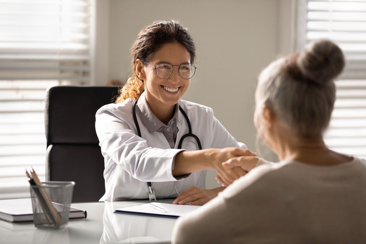 Medical professional shaking hands with patient